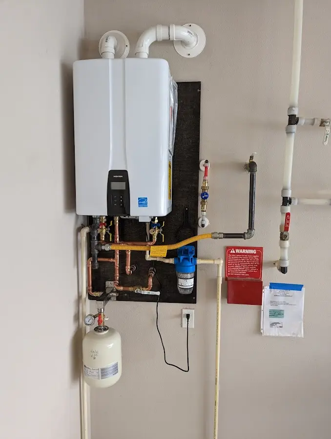 Professional plumber installing copper piping in a Wahoo home